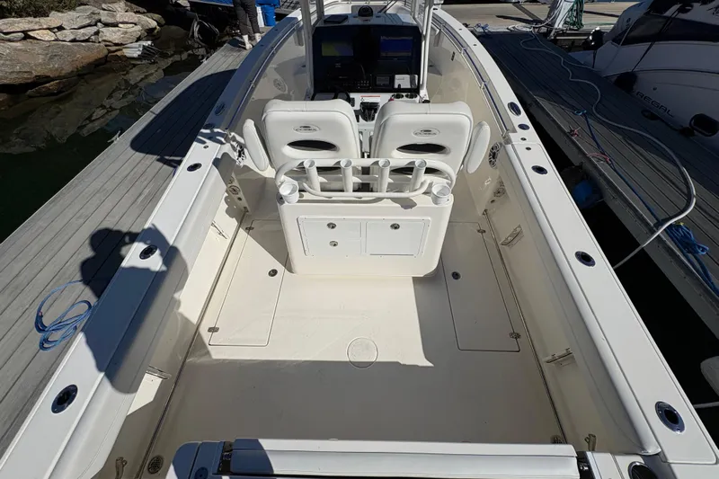  Yacht Photos Pics 2022 Cobia 280 Center Console boat interior with seating and control panel.