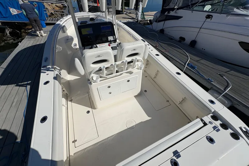  Yacht Photos Pics 2022 Cobia 280 Center Console boat docked, showcasing spacious deck and seating area.