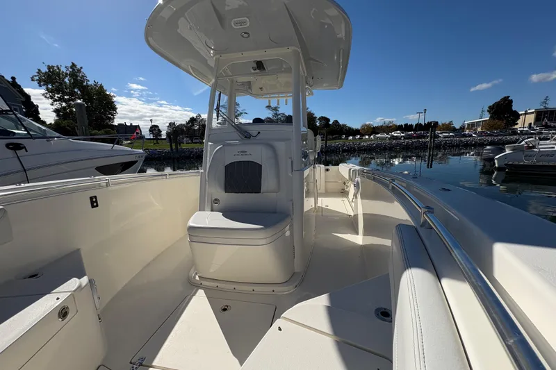  Yacht Photos Pics 2022 Cobia 280 Center Console boat docked in a marina under clear blue skies.
