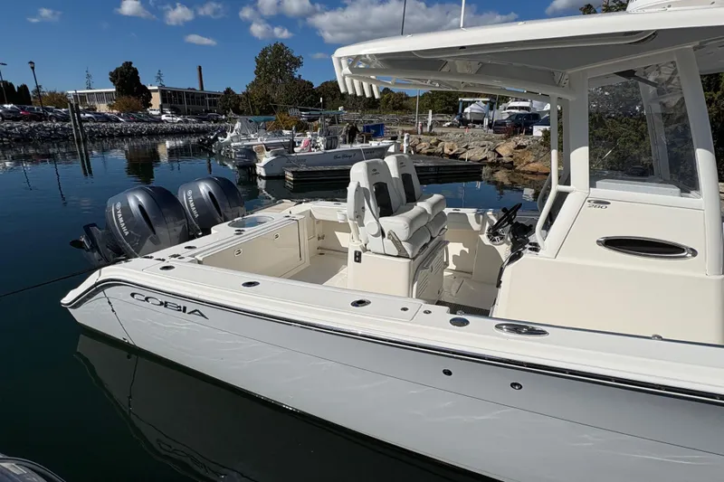  Yacht Photos Pics 2022 Cobia 280 Center Console boat docked with twin Yamaha engines.