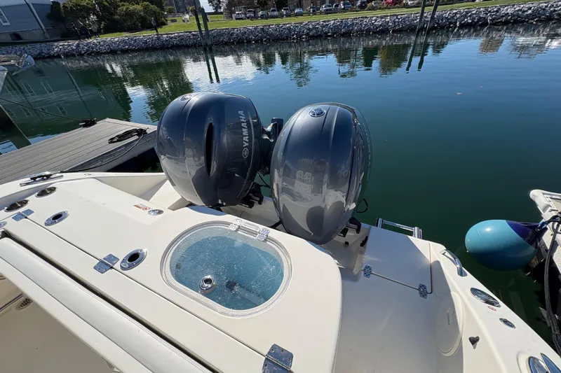  Yacht Photos Pics 2022 Cobia 280 Center Console with dual Yamaha outboard engines docked by the water.