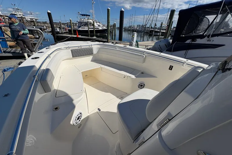  Yacht Photos Pics 2022 Cobia 280 Center Console boat docked at marina under clear blue sky.