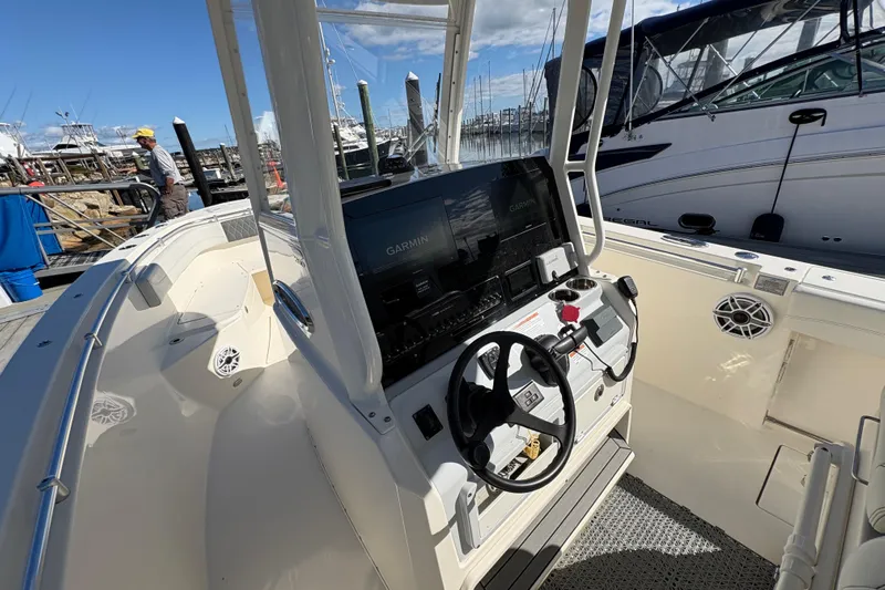  Yacht Photos Pics 2022 Cobia 280 Center Console boat interior with Garmin navigation system at marina.