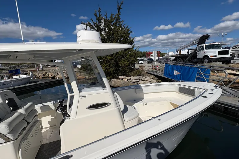  Yacht Photos Pics 2022 Cobia 280 Center Console boat docked under clear blue sky.