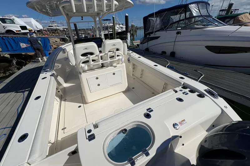  Yacht Photos Pics 2022 Cobia 280 Center Console boat docked, showcasing spacious deck and seating area.