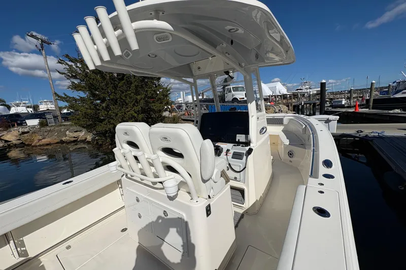  Yacht Photos Pics 2022 Cobia 280 Center Console boat docked, featuring spacious seating and modern controls.