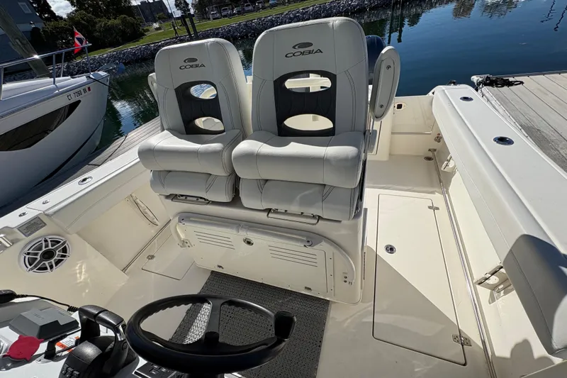  Yacht Photos Pics 2022 Cobia 280 Center Console boat interior with dual seats and steering wheel.