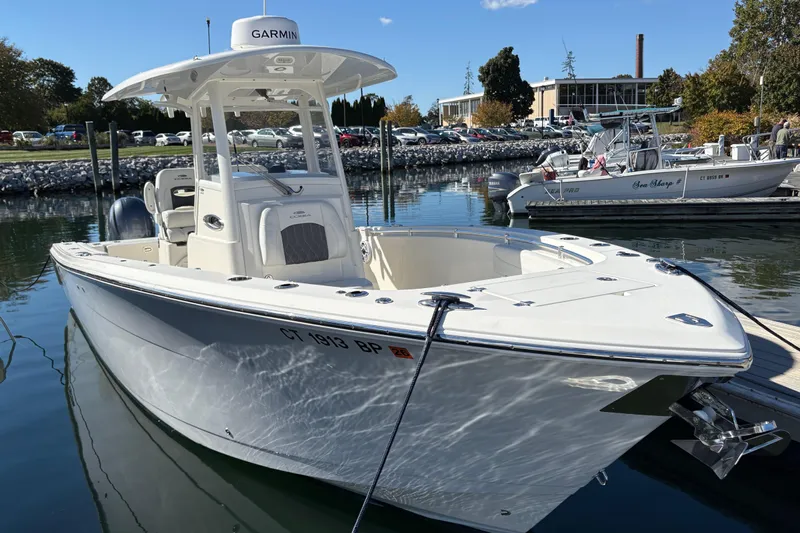  Yacht Photos Pics 2022 Cobia 280 Center Console boat docked in a marina under clear blue skies.