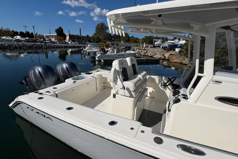  Yacht Photos Pics 2022 Cobia 280 Center Console boat with dual Yamaha engines docked in a marina.