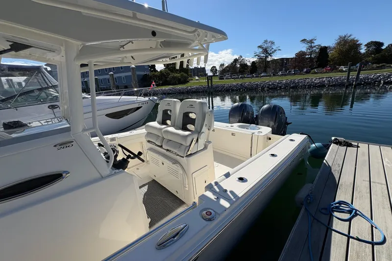  Yacht Photos Pics 2022 Cobia 280 Center Console boat docked, featuring dual engines and spacious seating.