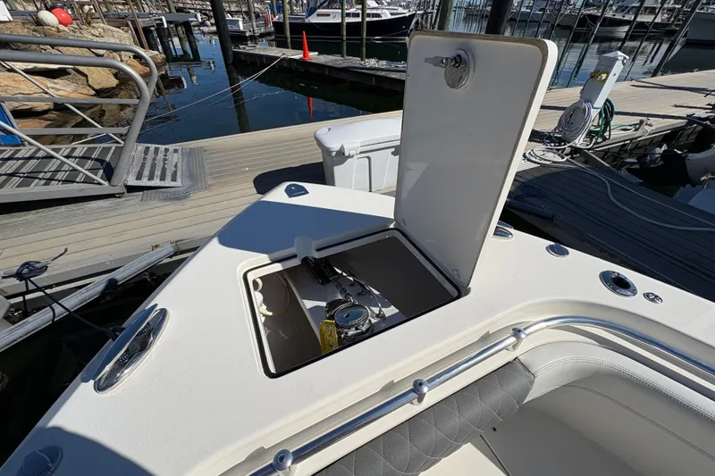  Yacht Photos Pics 2022 Cobia 280 Center Console boat with open storage compartment at marina dock.