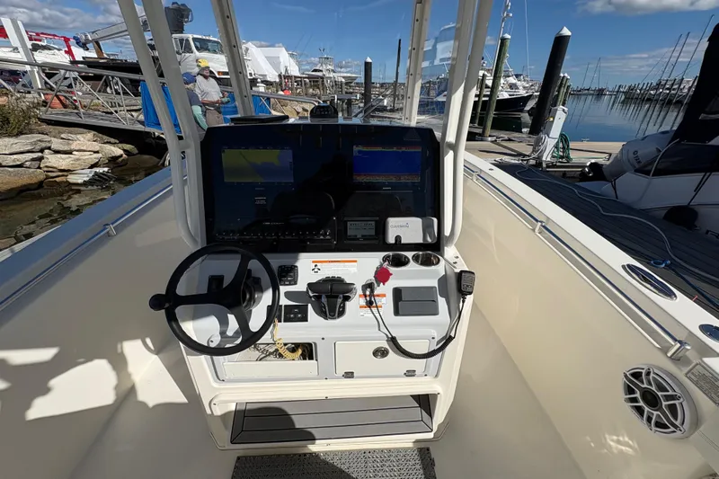  Yacht Photos Pics 2022 Cobia 280 Center Console boat dashboard with steering wheel and navigation equipment.