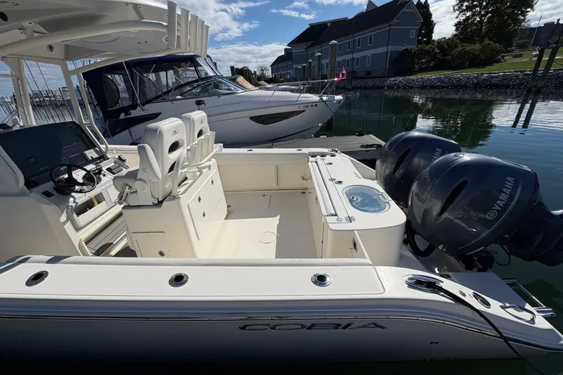  Yacht Photos Pics 2022 Cobia 280 Center Console boat with Yamaha engines docked in marina.