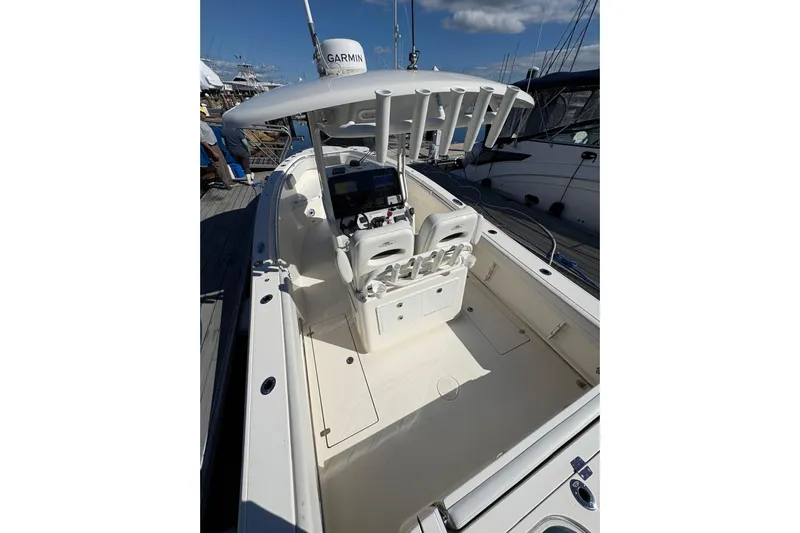  Yacht Photos Pics 2022 Cobia 280 Center Console boat with Garmin equipment, docked under a clear sky.