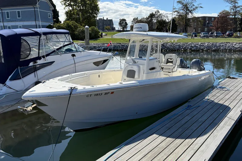  Yacht Photos Pics 2022 Cobia 280 Center Console boat docked at marina, sunny day.