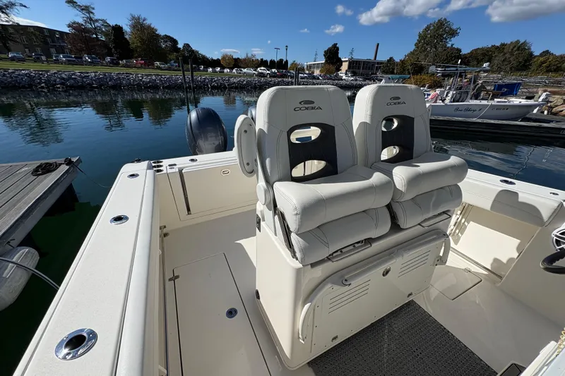  Yacht Photos Pics 2022 Cobia 280 Center Console boat interior with dual seats at dock.