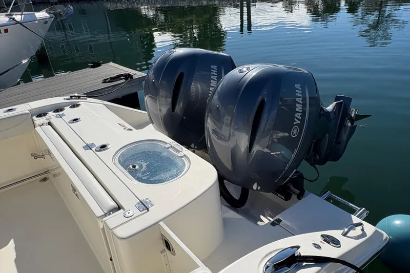  Yacht Photos Pics 2022 Cobia 280 Center Console boat with dual Yamaha outboard engines docked by the water.