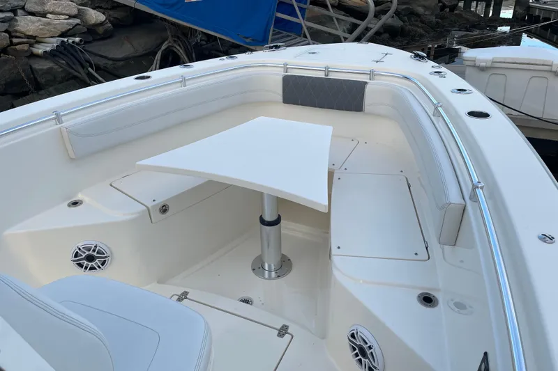  Yacht Photos Pics 2022 Cobia 280 Center Console boat interior with seating and table setup.