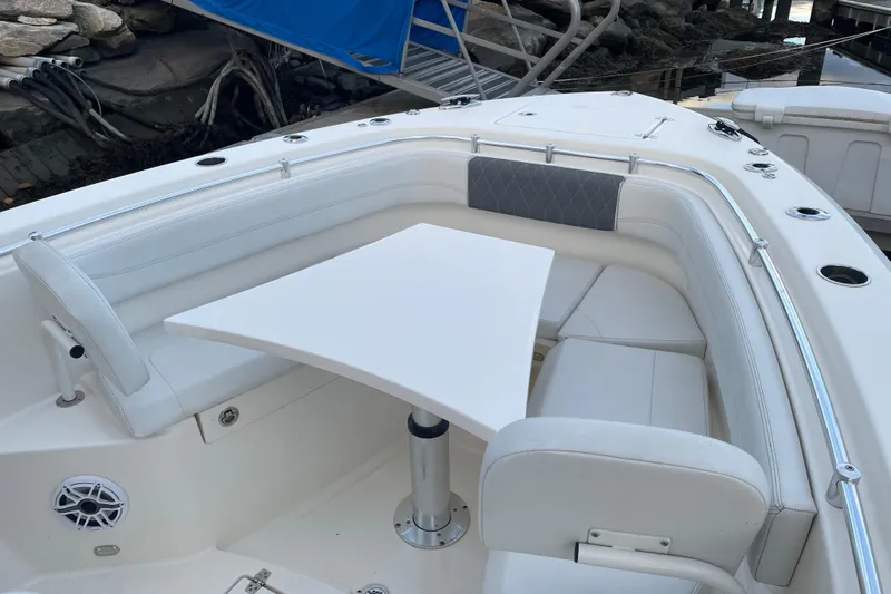 Yacht Photos Pics 2022 Cobia 280 Center Console boat interior with white seating and table.