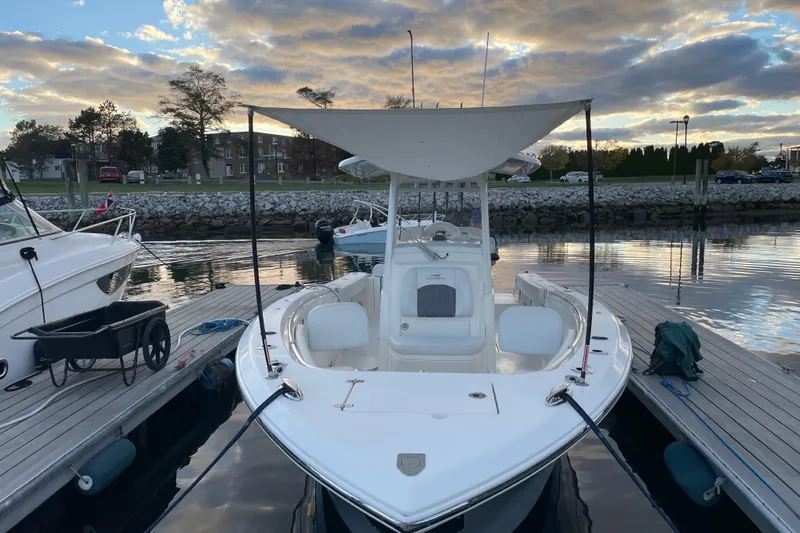  Yacht Photos Pics 2022 Cobia 280 Center Console boat docked at marina during sunset.