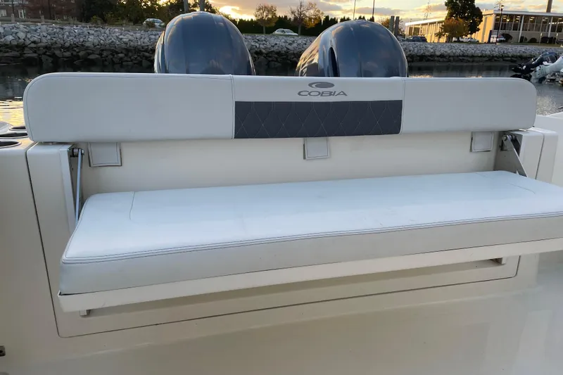  Yacht Photos Pics 2022 Cobia 280 Center Console boat with cushioned seating and dual engines.