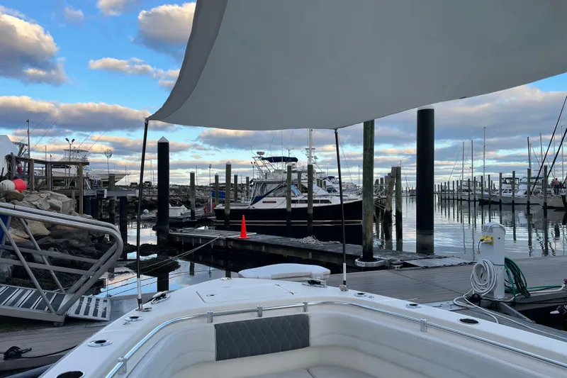  Yacht Photos Pics 2022 Cobia 280 Center Console docked at a marina under a cloudy sky.