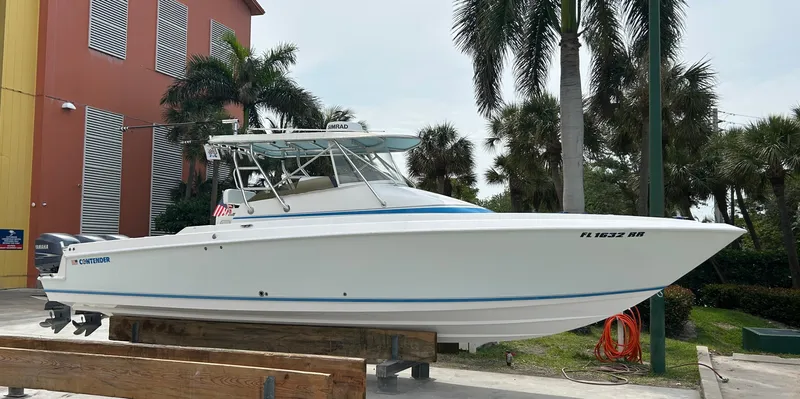  Yacht Photos Pics 2007 Contender 36 Fish Around boat on display near palm trees and building.
