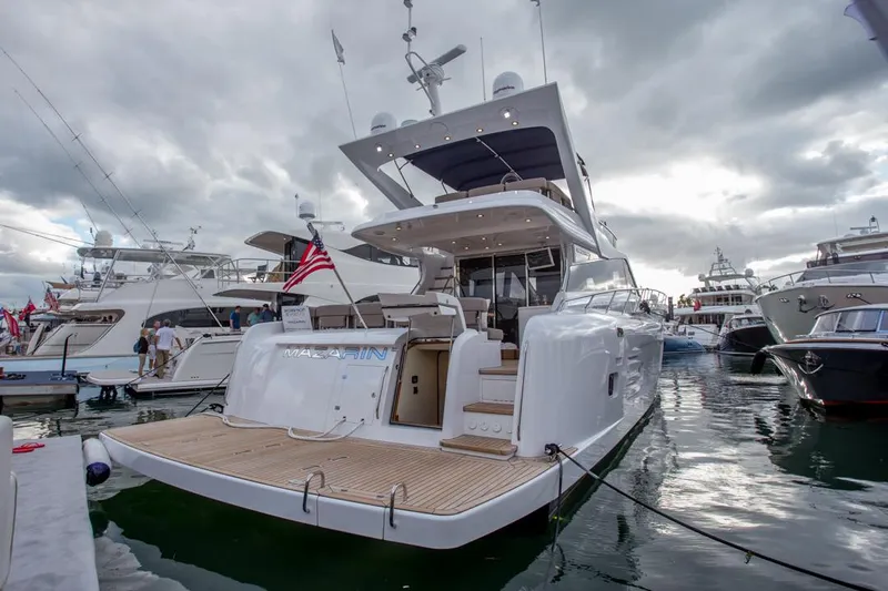  Yacht Photos Pics Luxurious 2015 Mazarin 72 Sport Fly yacht docked at marina under cloudy skies.