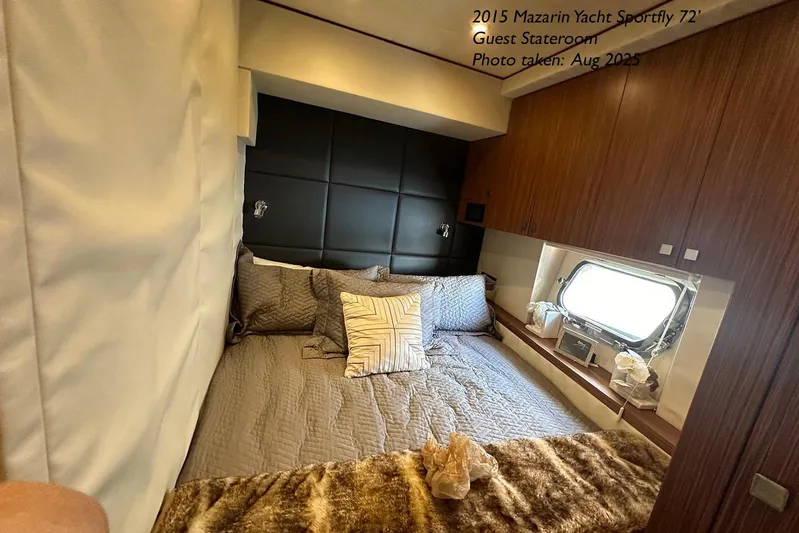 Yacht Photos Pics Luxurious guest stateroom in 2015 Mazarin 72 Sport Fly yacht, featuring elegant bedding and wood accents.