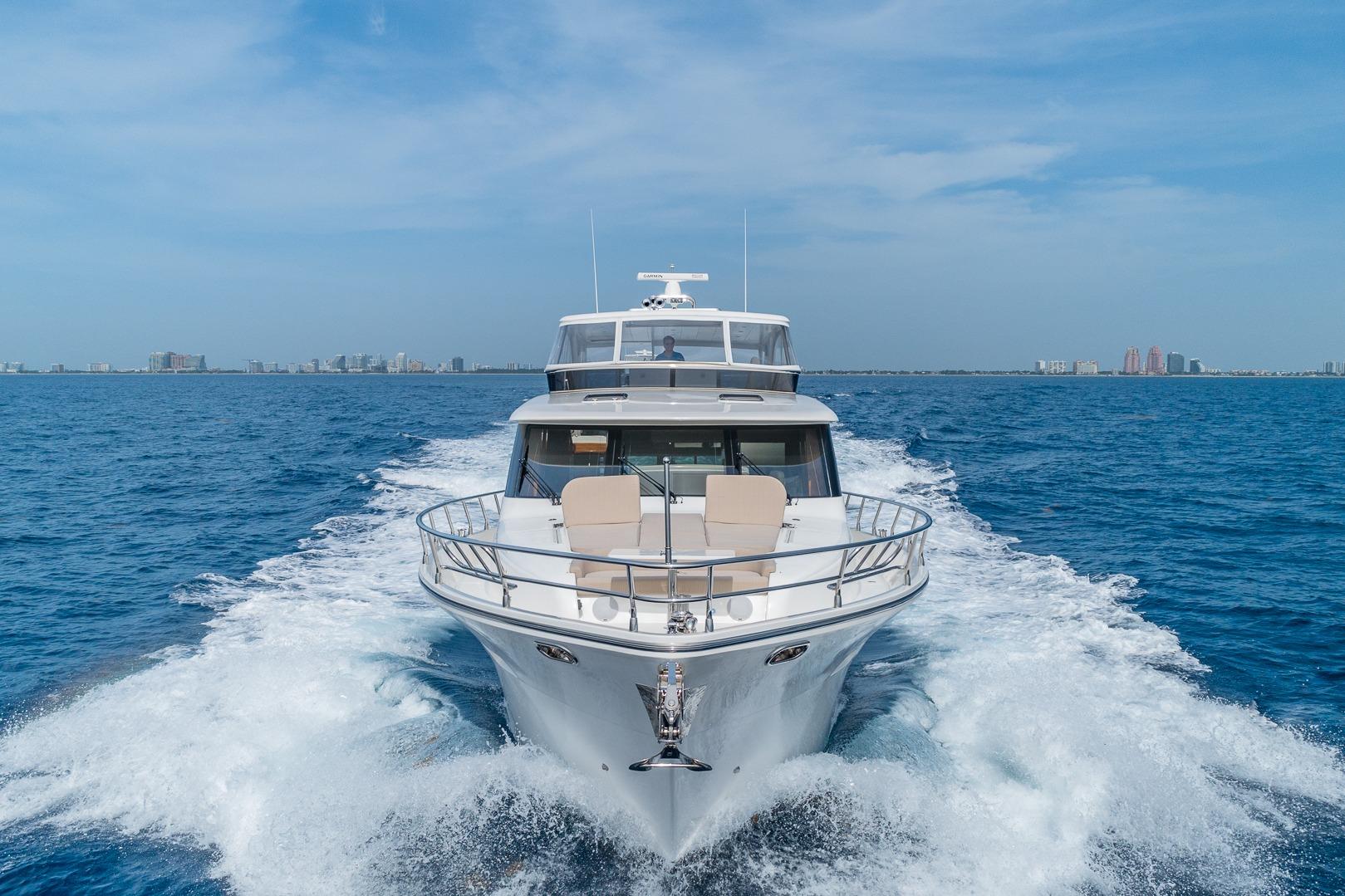 Luxurious 2019 Regency P65 yacht cruising on open blue sea.