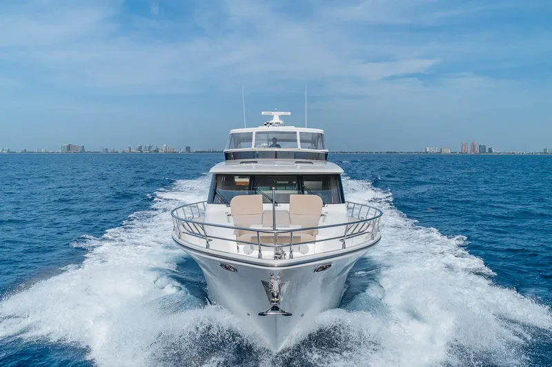  Yacht Photos Pics Luxurious 2019 Regency P65 yacht cruising on open blue sea.