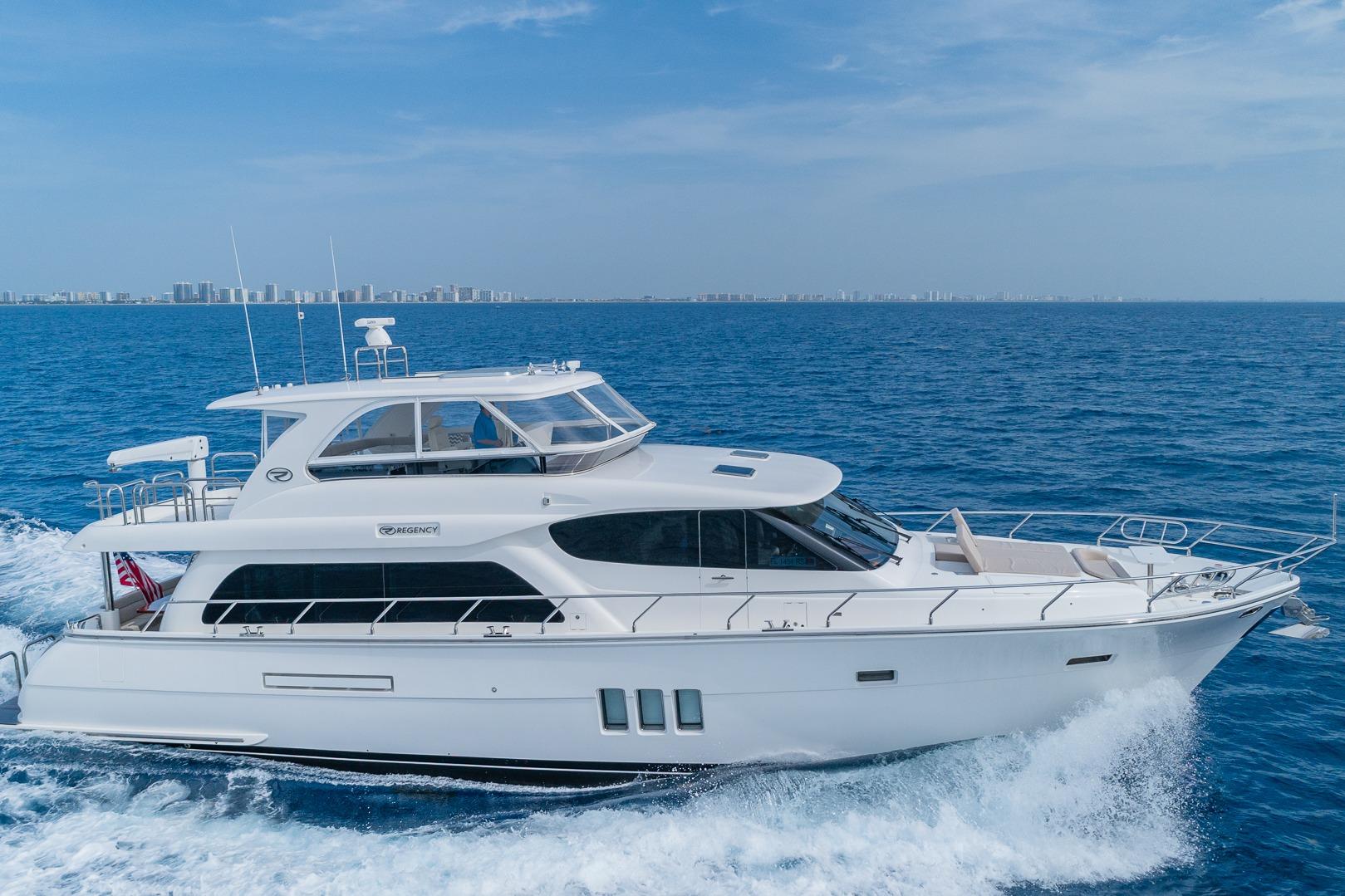 Luxurious 2019 Regency P65 yacht cruising on open blue sea.