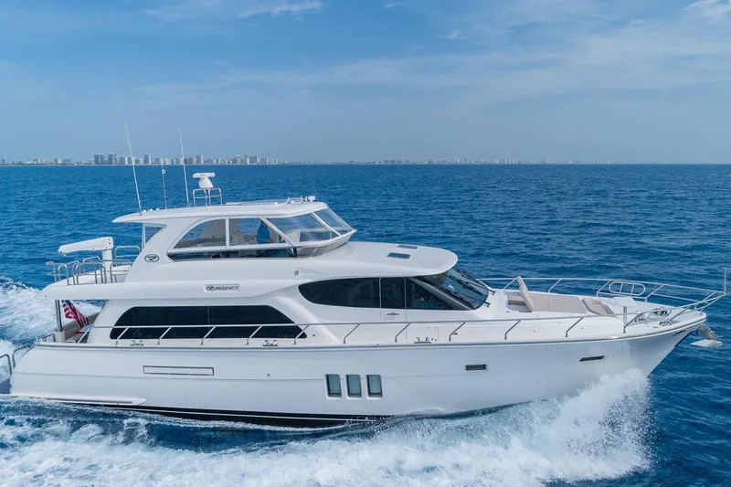  Yacht Photos Pics Luxurious 2019 Regency P65 yacht cruising on open blue sea.