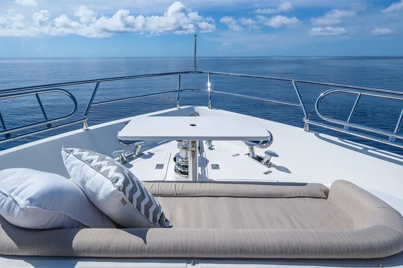  Yacht Photos Pics Luxurious 2019 Regency P65 yacht deck with cushions, table, and ocean view.