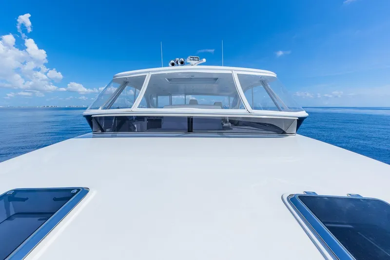  Yacht Photos Pics 2019 Regency P65 yacht cruising on open sea under clear blue sky.