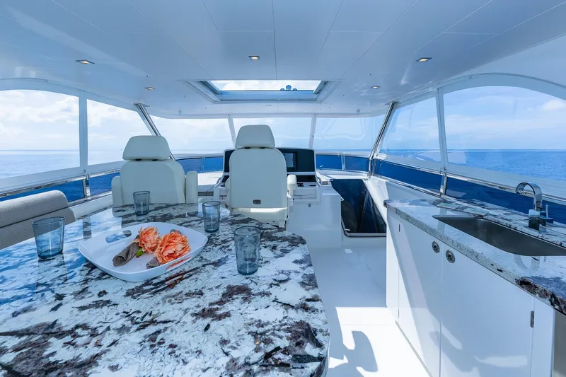  Yacht Photos Pics Luxurious 2019 Regency P65 yacht interior with marble countertops and ocean view.