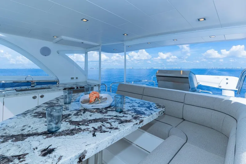  Yacht Photos Pics Luxurious Regency P65 yacht interior with marble table, ocean view, and modern seating, 2019 model.