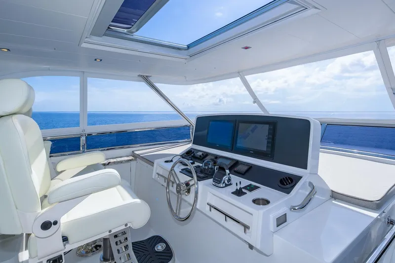  Yacht Photos Pics Luxurious 2019 Regency P65 yacht helm with ocean view, featuring modern navigation equipment.