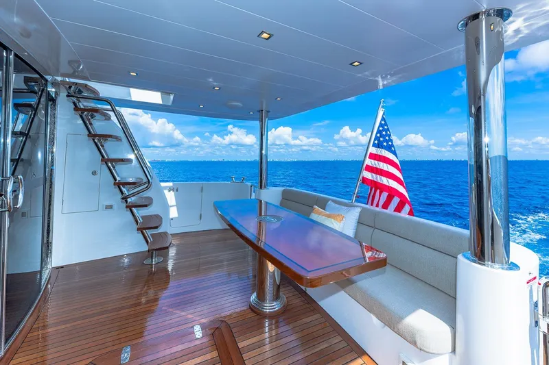  Yacht Photos Pics Luxurious Regency P65 yacht deck with seating, table, and ocean view, 2019 model.