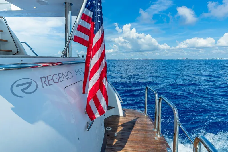  Yacht Photos Pics Regency P65 yacht with American flag on open ocean, 2019 model.