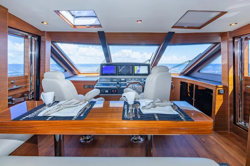  Yacht Photos Pics Luxurious 2019 Regency P65 yacht interior with elegant dining setup and panoramic ocean views.