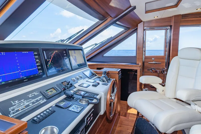  Yacht Photos Pics Luxurious 2019 Regency P65 yacht helm with advanced navigation systems and plush seating.