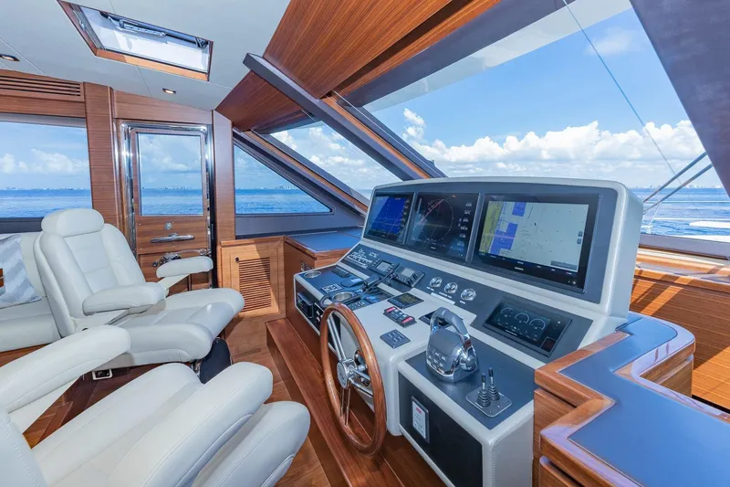  Yacht Photos Pics Luxurious 2019 Regency P65 yacht helm with advanced navigation systems and plush seating.