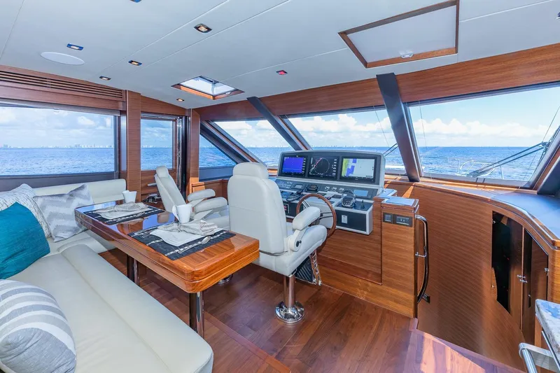 Yacht Photos Pics Luxurious 2019 Regency P65 yacht interior with helm, dining area, and ocean view.
