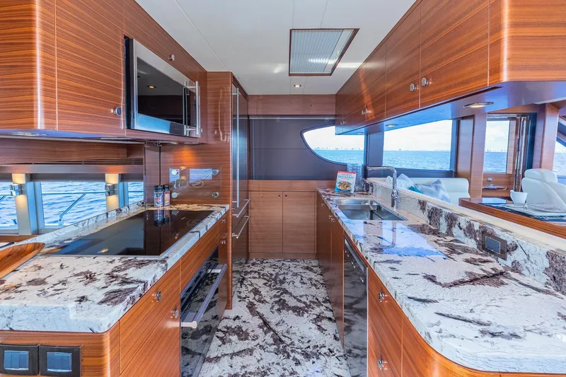  Yacht Photos Pics Luxurious kitchen interior on 2019 Regency P65 yacht with marble countertops and ocean view.