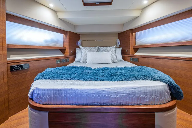  Yacht Photos Pics Luxurious bedroom interior of 2019 Regency P65 yacht with plush bedding and modern design.