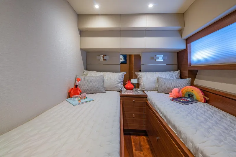  Yacht Photos Pics Luxurious twin cabin in 2019 Regency P65 yacht with plush bedding and decor.