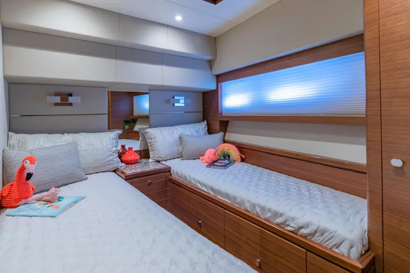  Yacht Photos Pics Luxurious 2019 Regency P65 yacht bedroom with twin beds and plush decor.