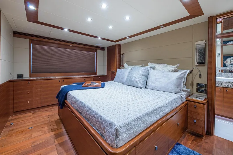  Yacht Photos Pics Luxurious bedroom interior of 2019 Regency P65 yacht with elegant wood finishes.