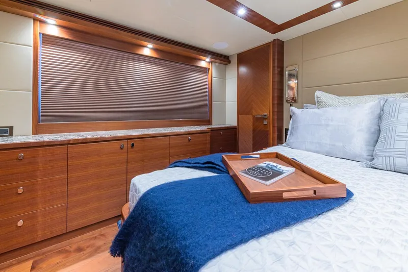  Yacht Photos Pics Luxurious 2019 Regency P65 yacht bedroom with elegant wood finishes and cozy bedding.